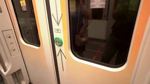 4K video of hand pressing green emergency button on orange train door in Si.. Stock Footage 335169918
