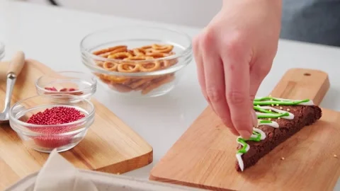 4K Video Hands Decorating Chocolate Brownie Green Icing Sprinkles Stock Footage 330423828