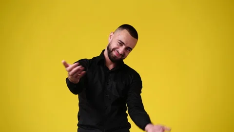 4k video of handsome man gesturing come on here over yellow background. Stock Footage 226687060