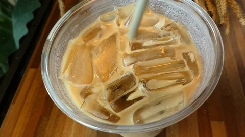 4K video ice coffee in a plastic cup on the table, 스톡 동영상 97341913