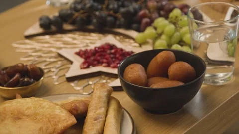 4K Video Iftar Meal Spread Dates Gulab Jamun Samosas and Flatbread Stock Footage 330424180