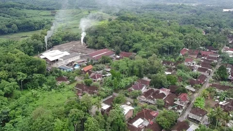 4k video of an industrial area surrounded by rural houses Stock Footage 295701425