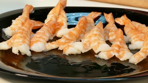 4k video. Large cooked shrimp spread on a black plate Stock Footage 70506769