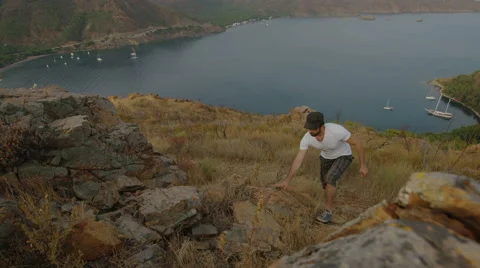 4k video of a man climbing to a mountain and opening his arms. Slow motion. Stock Footage 40468586