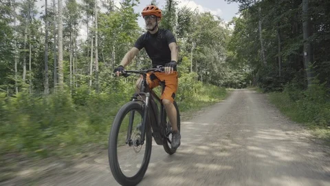 4K video man cycling on e mountain bike on forest road Stock Footage 91241193