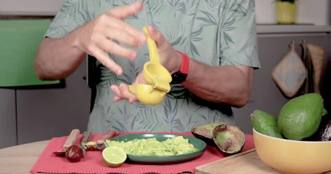 4K Video of Man Squeezing Lemon on Hass Palta with Juicer Stock Footage 278688008
