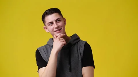 4k video of a man thinking about something over yellow background. Stock Footage 234469500