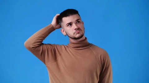 4k video of a man thinking about something over blue background. Stock Footage 234536048