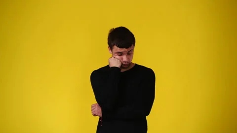 4k video of a man thinking about something over yellow background. Stock Footage 239612312