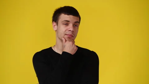 4k video of a man thinking about something over yellow background. Stock Footage 240442763