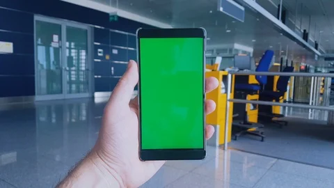 4K video of man using mobile phone with green screen in airport Stock Footage 98107128
