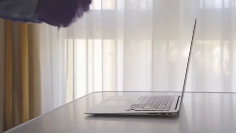4k video of man writing in a notebook in front of his computer with his glove Stock Footage 129909477