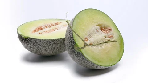 4K video of a melon cut in half rotating on a white background. Stock Footage 277436838