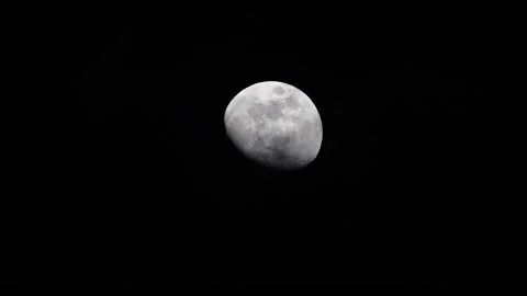 4K video of the moon in night sky with clouds slowly passing in front Stock Footage 331785404