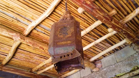 4K video of an old lantern hanging on a bamboo ceiling Stock Footage 115208736