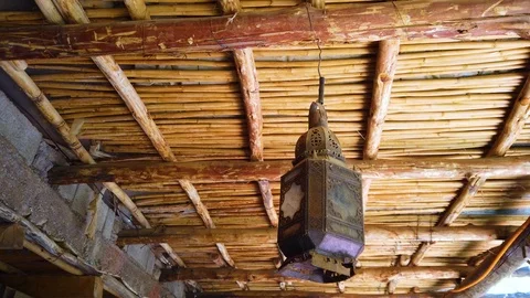 4K video of an old lantern hanging on a bamboo ceiling Stock Footage 115208743
