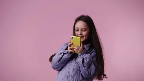4k video of one child typing text laughingly over pink background. Stock Footage 243321114
