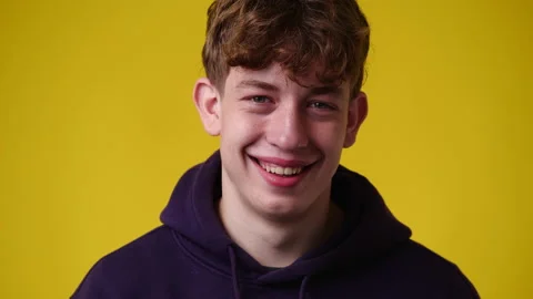 4k video of one curly man smiling on yellow background. Stock Footage 233116071