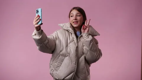 4k video of one girl using her phone over pink background. Stock Footage 237276950