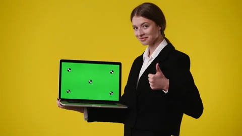 4k video of one girl using chroma key laptop and showing thumbs up over yellow Stock Footage 237610512