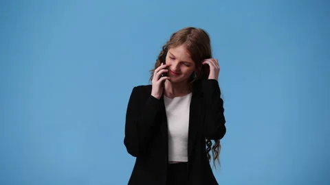 4k video of one girl using her phone over blue background. Video stock 238027148