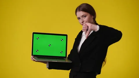 4k video of one girl using chroma key laptop and showing thumbs down over yellow Stock Footage 238988422