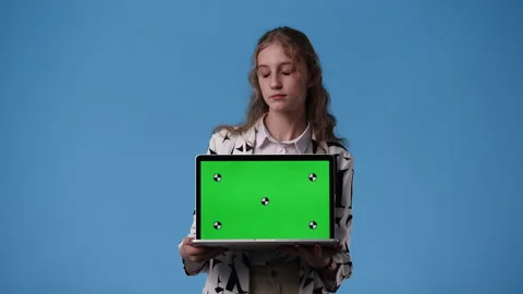 4k video of one girl using chroma key laptop and smiling over blue background. Video stock 240771525