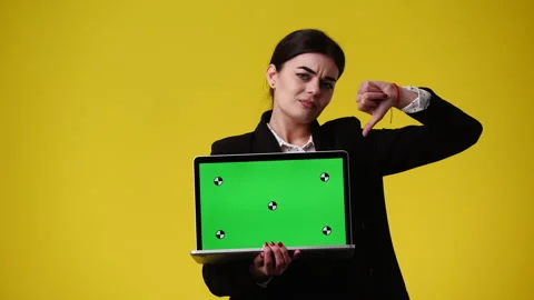 4k video of one girl using chroma key laptop and showing thumbs down over yellow Stock Footage 242036899