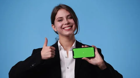 4k video of one girl using chroma key phone over blue background. Stock Footage 242595457