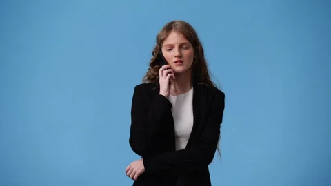 4k video of one girl using her phone over blue background. Stock Footage 242601941