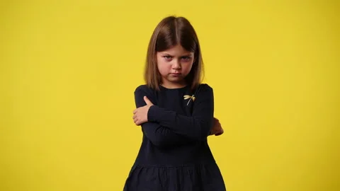 4k video of one kid with a negative facial expression who crosses her arms over Stock Footage 238516631