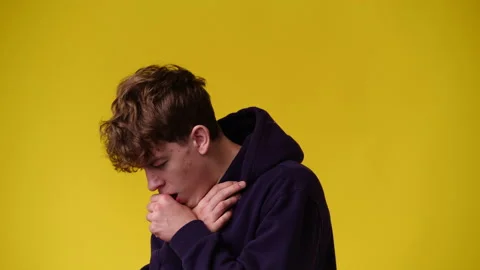 4k video of one man coughing and clutching his chest over yellow background. Stock Footage 233227710