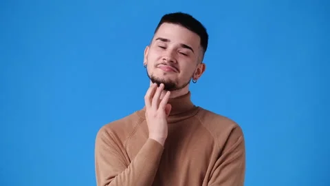 4k video of one man with cunning facial expression on blue background. Stock Footage 226242428