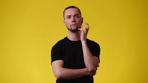 4k video of one man doubts and thinking about something over yellow background. Stock Footage 240362236