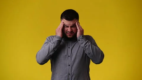 4k video of one man having headache over yellow background. Video stock 240088617