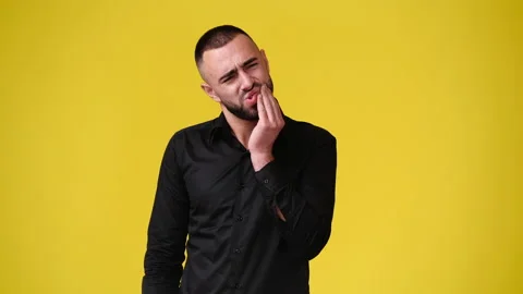 4k video of one man with negative facial expression on yellow background. Stock Footage 235216880