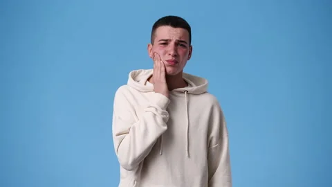 4k video of one man with negative facial expression on blue background. Video stock 237633568