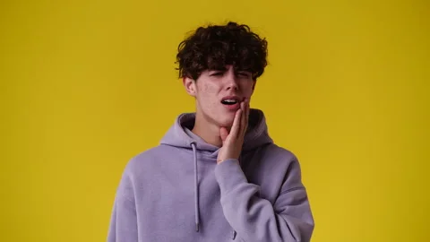 4k video of one man with negative facial expression on yellow background. Video stock 240671787