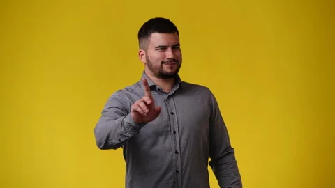 4k video of one man with negative facial expression on yellow background. Stock Footage 243627577