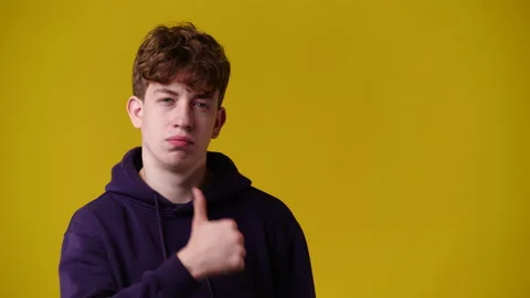 4k video of one man pointing at right and showing thumb up over yellow Video stock 231647867