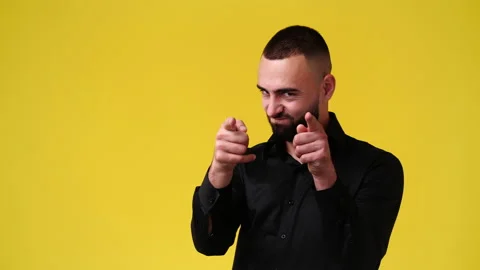 4k video of one man pointing at someone over yellow background. Stock Footage 233107331
