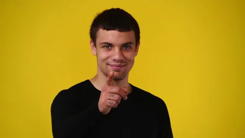 4k video of one man pointing at camera over yellow background. Stock Footage 239608888