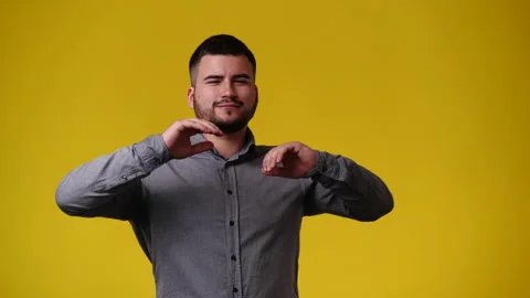 4k video of one man posing for a video over yellow background. Stock Footage 240089249