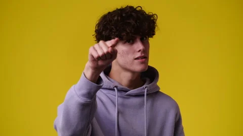 4k video of one man with positive facial expression showing finger. over yellow Stock Footage 237614070
