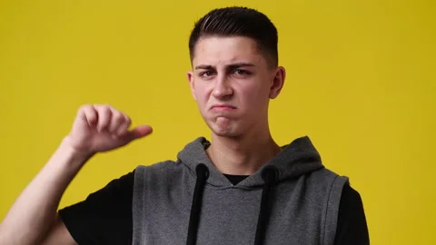 4k video of one man showing thumb down over yellow background. Stock Footage 234537408