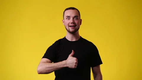 4k video of one man showing thumb up over yellow background. Stock Footage 237240345