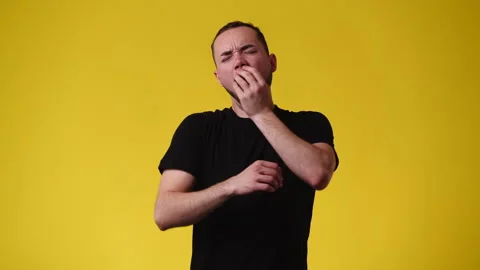 4k video of one man sipping and wakes up over yellow background. Video stock 240201335