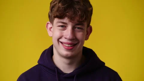 4k video of one man smiling on yellow background. Video stock 231645835