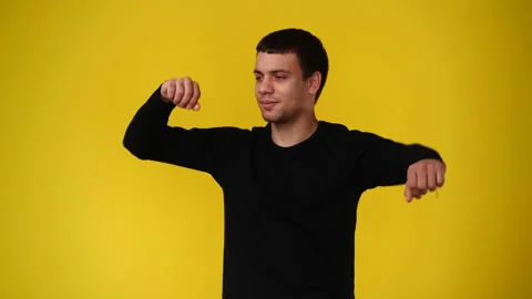 4k video of one man smiling and dancing over yellow background. Stock Footage 237711269