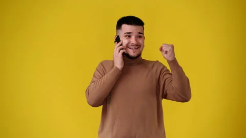 4k video of one man using phone over yellow background. Stock Footage 235391627